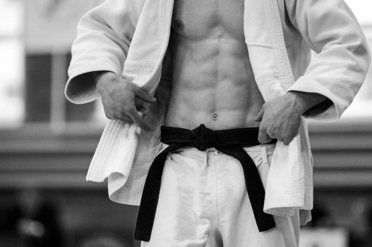 Judo,Athlete,In,White,Kimono,And,Black,Belt,Black,And